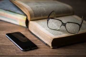 glasses lying on a book symbolizing learning SEO