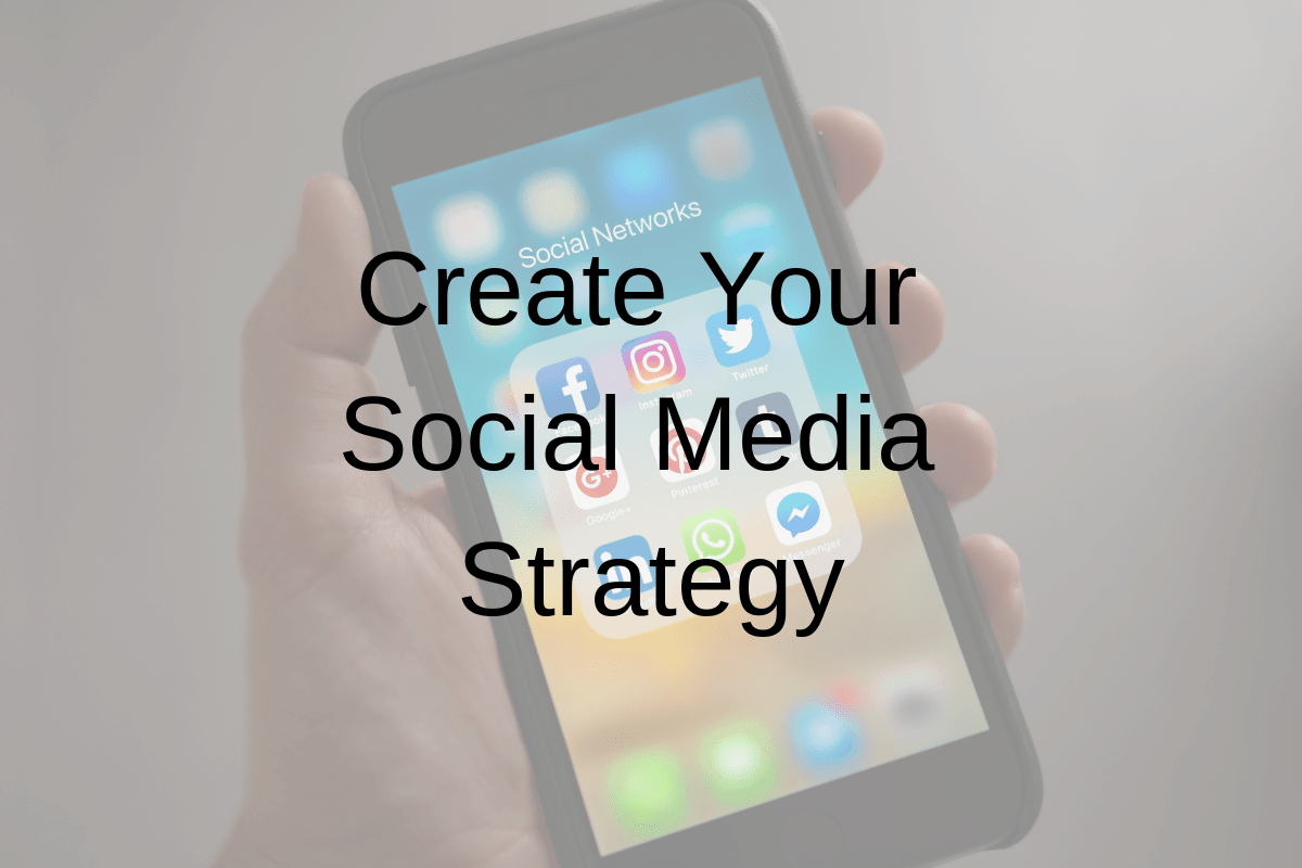 Phone with social media icons and the caption "Create Your Social Media Strategy".